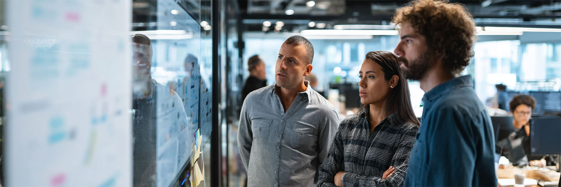 IT professionals collaborating on DevOps workflows in a modern enterprise office setting