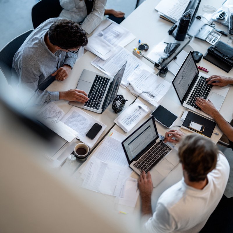 Professionals preparing for AWS certification with laptops, cloud labs, and study materials in a clean training environment