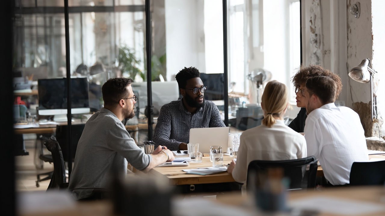 Corporate training team collaborating in a modern office