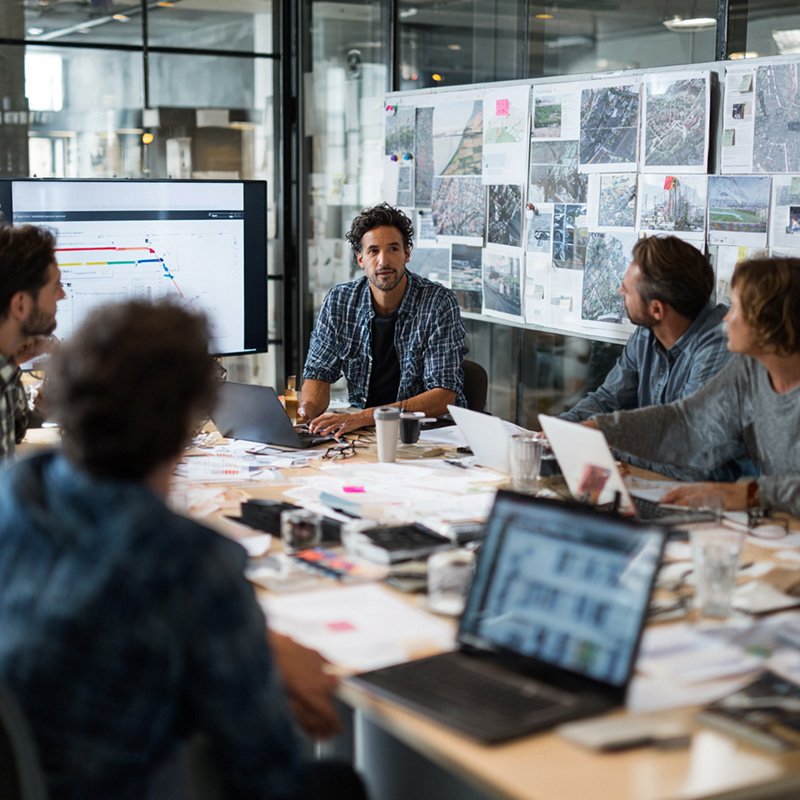 Corporate team discussing flexible training development options during a project meeting