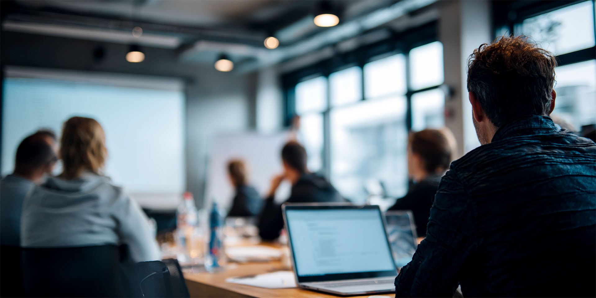 Professionals in a modern office engaged in a corporate training session